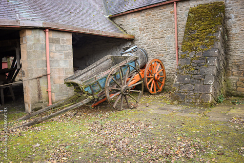Wallpaper Mural A pair of old wooden carts standing in an stone farmyard. Torontodigital.ca