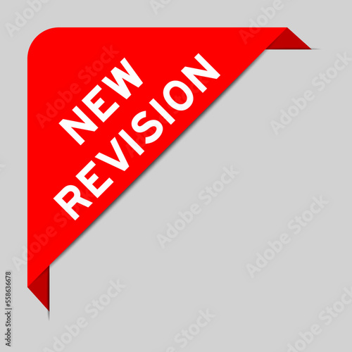 Red color of corner label banner with word new revision on gray background