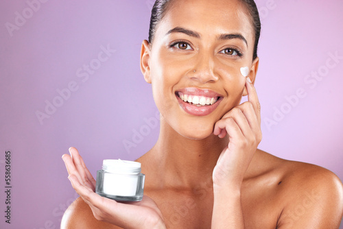 Woman, skincare cream and portrait with smile, cosmetic beauty and healthy facial by lavender background. Model, face and cosmetics for natural glow, happiness and product by purple studio background