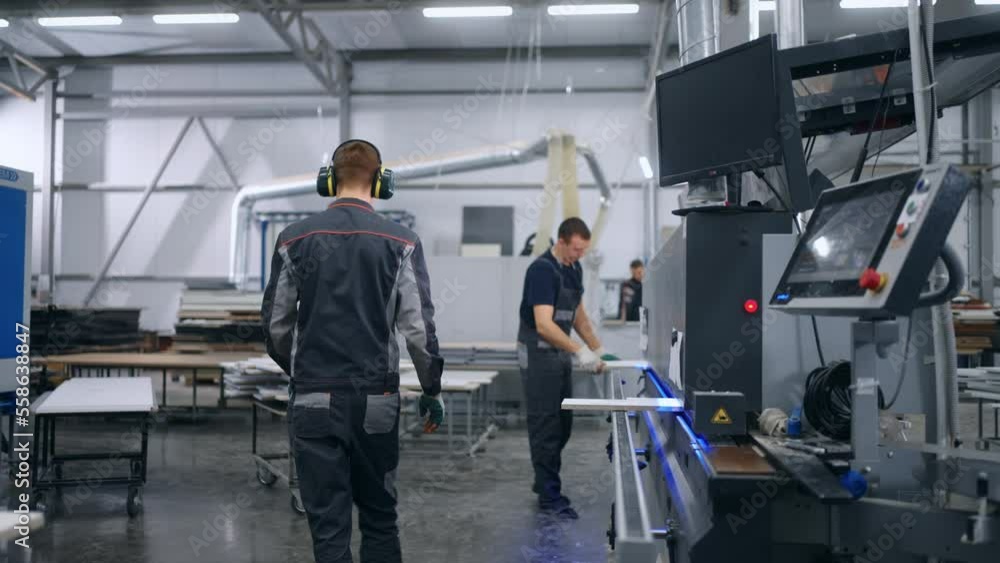 production of furniture and building materials in modern factory, workers work with modern equipment production of furniture and building materials in modern factory, workers work with modern equipment