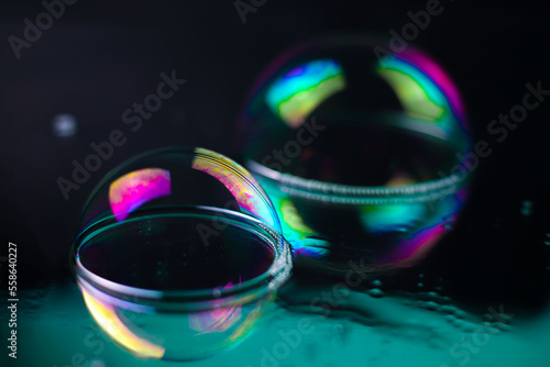 bright rainbow multicolored cosmic futuristic transparent shiny textures in the form of soap bubbles on a mirror surface with water drops. for business cards labels headpieces signs flyers © Наталья Николаева