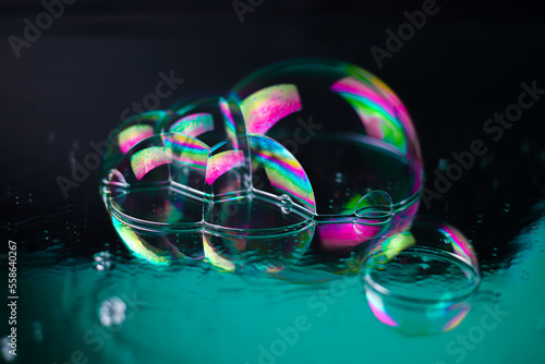 bright rainbow multicolored cosmic futuristic transparent shiny textures in the form of soap bubbles on a mirror surface with water drops. for business cards labels headpieces signs flyers