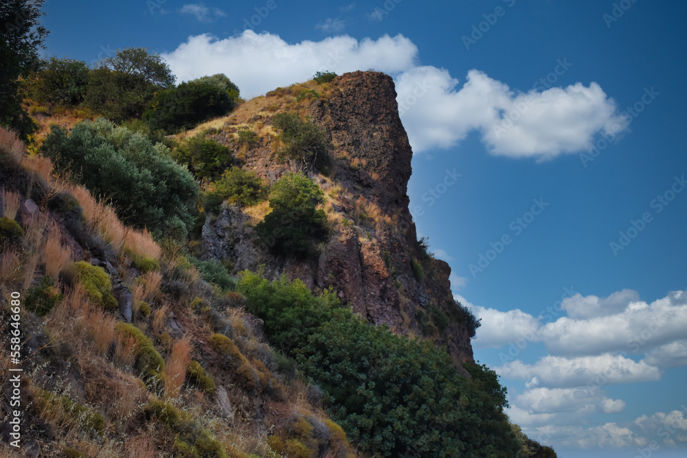 Fototapeta premium Cloud clusters and sky view from the top of a mountain with various dwarf Mediterranean scrub plants