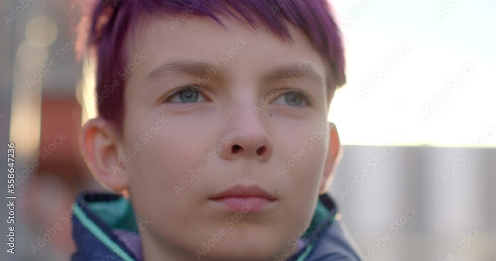 Portrait of a teenager, close-up of the face. Blue eyes, sunlight, dyed hair. Deep gaze, blinking eyes. Portrait of a teenager, close-up of the face. Blue eyes, sunlight, dyed hair. Deep gaze, blinking eyes.