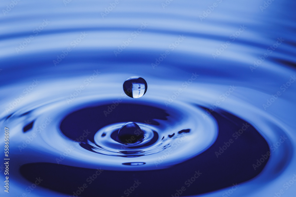 Clear blue water drop splash with circular waves