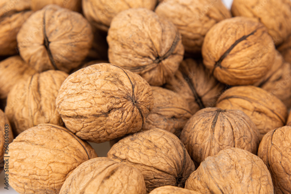 Walnut in shell isolated on white background. Energy boost for the day. The concept of proper nutrition. Tasty breakfast. Walnut in shell isolated on white background. Energy boost for the day. The concept of proper nutrition. Tasty breakfast.