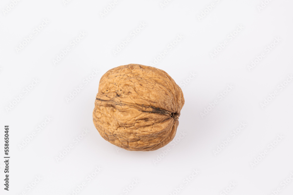 Walnut in shell isolated on white background. Energy boost for the day. The concept of proper nutrition. Tasty breakfast. Walnut in shell isolated on white background. Energy boost for the day. The concept of proper nutrition. Tasty breakfast.