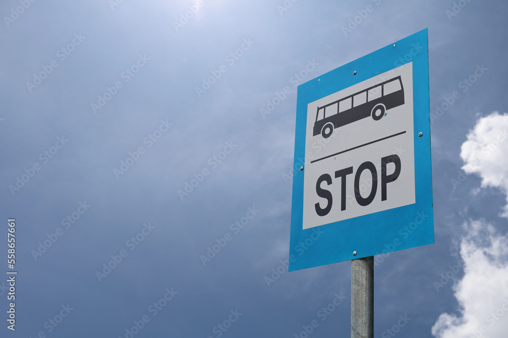 Bus stop sign in the street against blue sky Bus stop sign in the street against blue sky