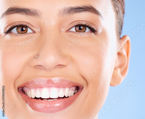 Teeth  dental and face portrait of woman with clean smile  teeth whitening and oral self care on blue background. Tooth implant  healthcare and beauty model with makeup  cosmetics and facial skincare