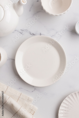 Empty tableware - white plate a bowl and a cup on white table as a background for a dish foodbackground