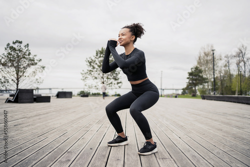Fitness woman workout jumps outdoors in urban environment