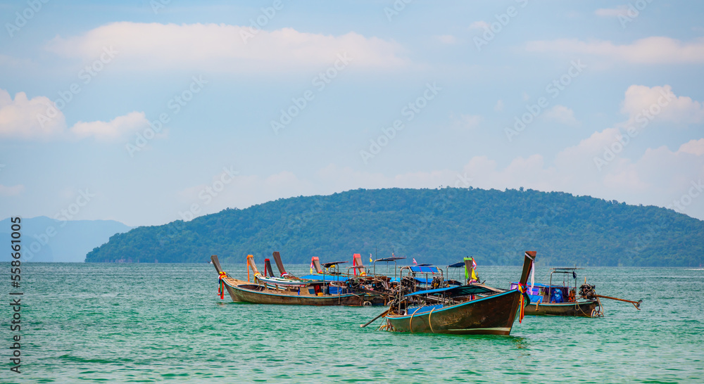 Long tail boats at Railay beach, Krabi, Thailand. Tropical paradise, turquoise water and white sand.