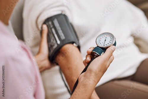 Blood pressure, hypertension and nurse with patient to check diabetes, healthcare consulting and service in clinic. Closeup hands of woman doctor measure arm pulse, medical test and heart wellness photo