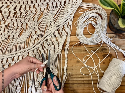 An artist working on an arts and crafts macrame at home