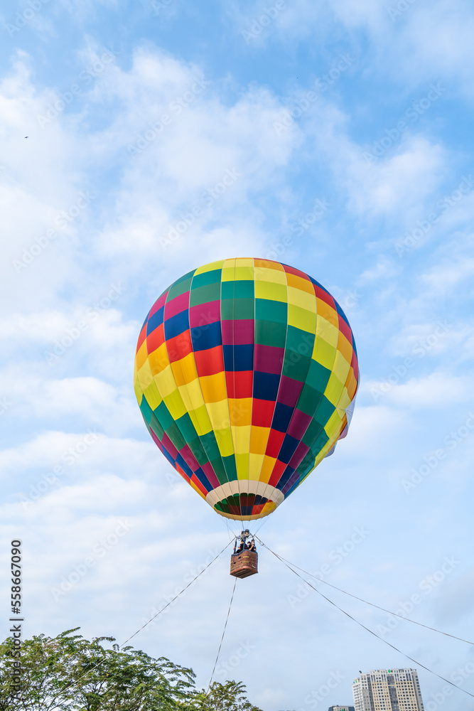 Fototapeta premium A hot-air balloon festival kicked off on January 22, 2022 to celebrate the first founding anniversary of Thu Duc City, colorful hot air balloon in blue sky