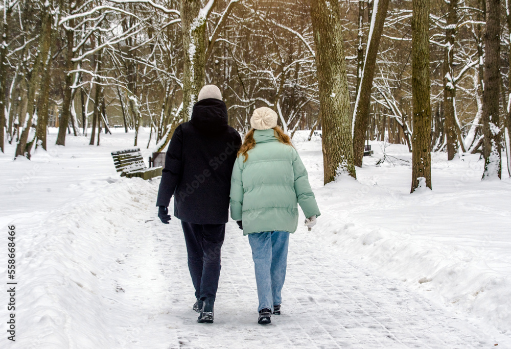 A guy and a girl walking in winter Park
A guy and a girl walking in winter Park