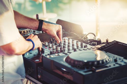 DJ is mixing music with deejay controller at outdoor summer pool party - nightli Fototapet