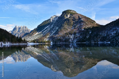 View of Lago del Predil near Tarvisio in Friuli-Venezia Giulia region of Italy and a reflection of the mountains above in the water