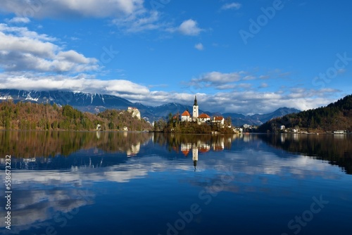 View of the church of the assumption on an island on lake Bled and Bled castle in Gorenjska, Slovenia