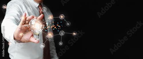Businessman holding light bulb on hand with cloud computing global internet connection application technology. Cloud computing and internet networking transfers worldwide information.
