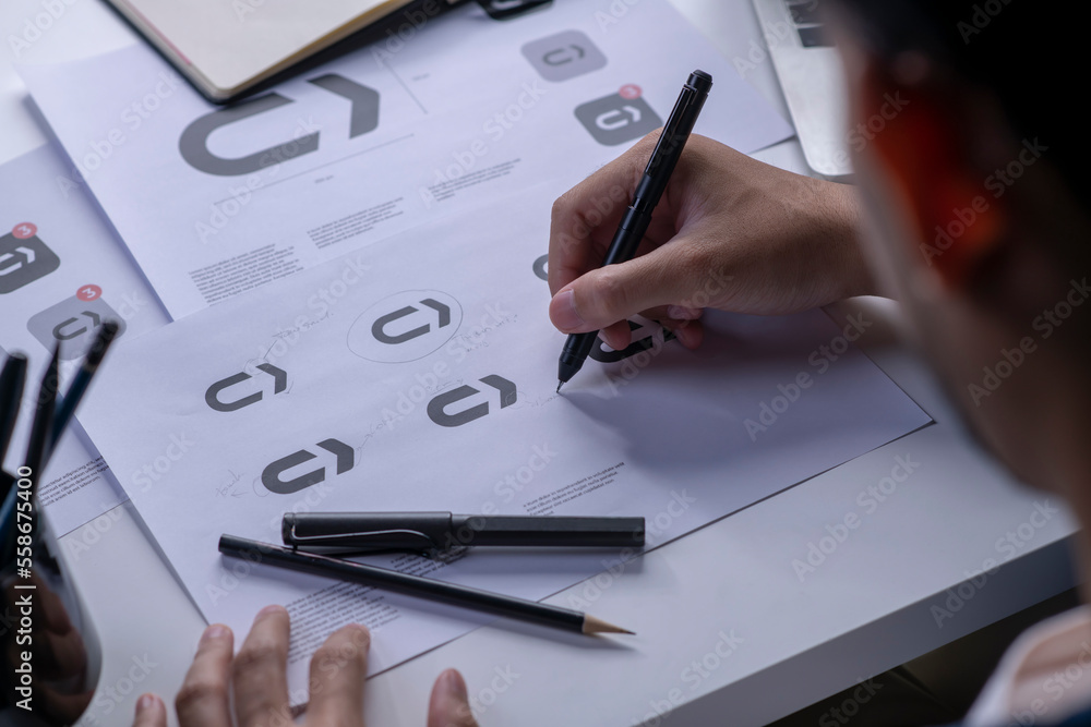 Fotografie Graphic designer drawing sketches logo design