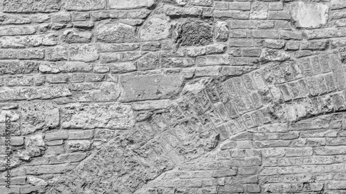 Old grungy clear retro brick wall of ancient city. Uneven soft pitted peeled surface brickwork of cellar worn. Ruined solid bumpy stiff blocks. Hard simple ragged holes brickwall for 3D grunge design