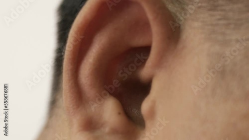 Close-up of ear, Asian man with hearing problems, congenital deafness