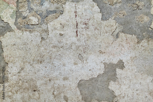 Old rustic grungy aged painted facade of rusty smudged daub. Rough grime edged wall. Wrinkled uneven plastering. Cracked chipped messy falling stucco.Dirty vintage flaking textured layer for 3D design
