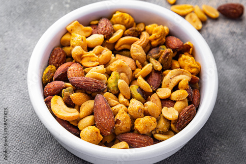 nut salt snack mix almond, cashew, pistachio, peanut fresh nuts food on the table copy space food background rustic top view