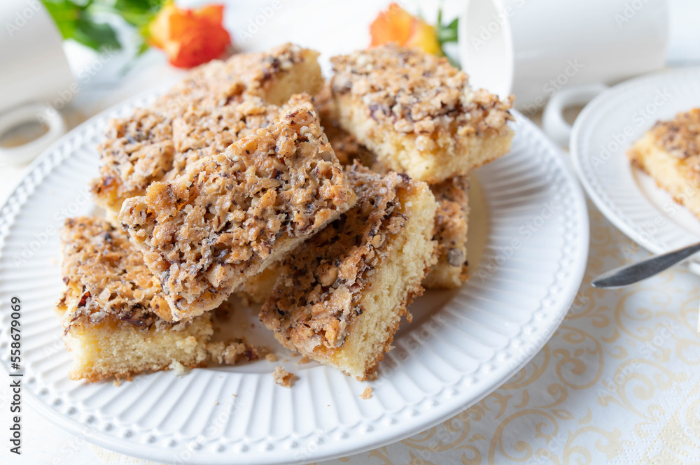 Plate with slices of hazelnut cake on white background Plate with slices of hazelnut cake on white background