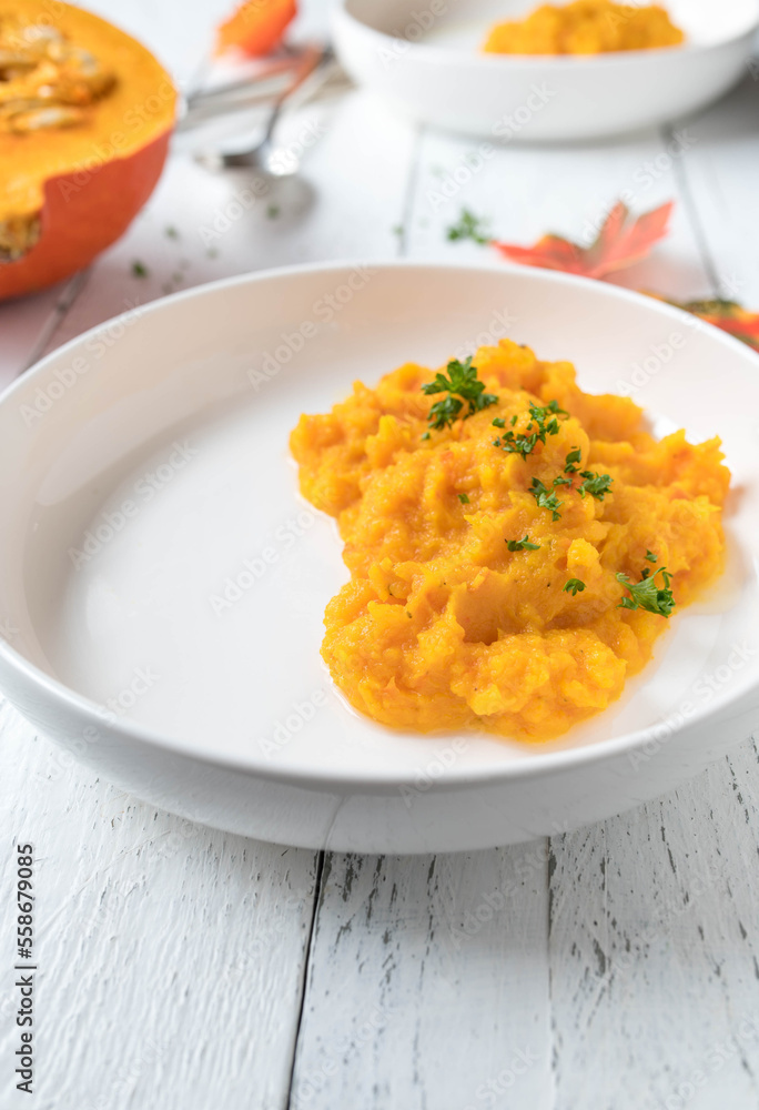 Squash puree served for side dish on a plate on white background.