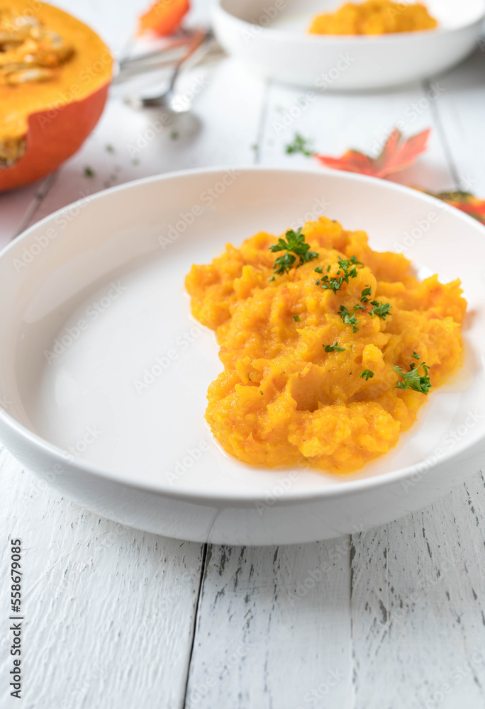 Squash puree served for side dish on a plate on white background. Squash puree served for side dish on a plate on white background.