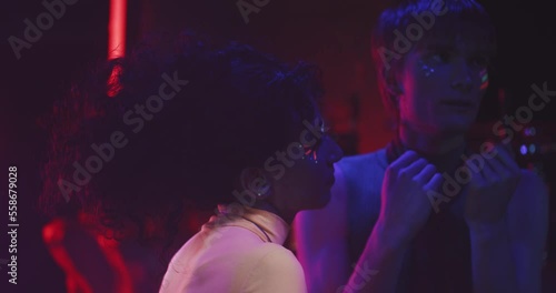 Lgbt couple dancing in a party blue lights photo