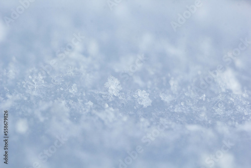 natural snowflakes on snow, photo of real snowflakes. Winter snow background. Snowflake close-up. Macro photo. Copy space.