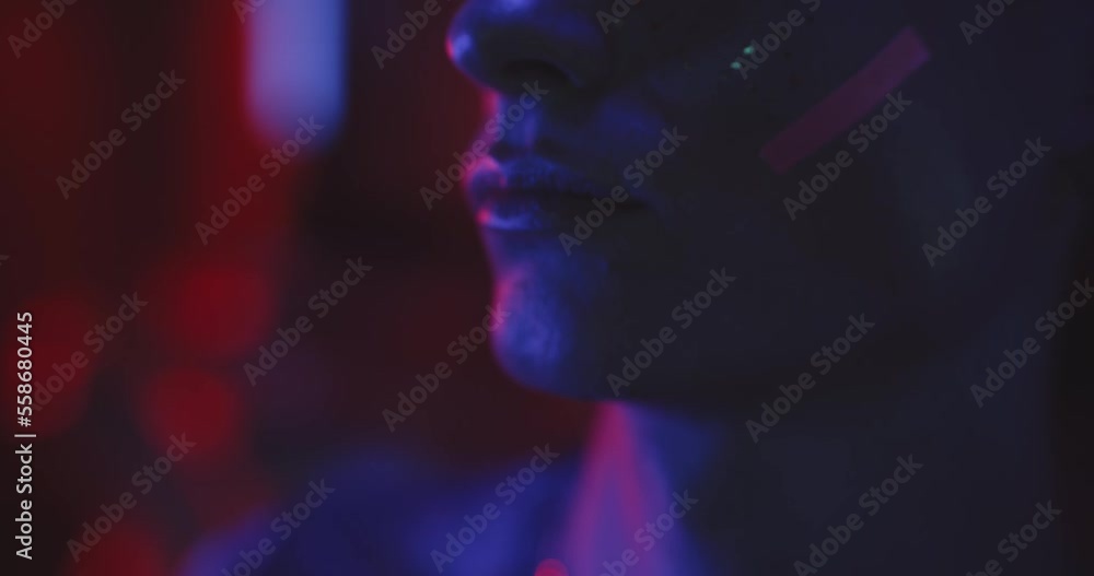 Close up lips of a young man in makeup in blue lights Close up lips of a young man in makeup in blue lights