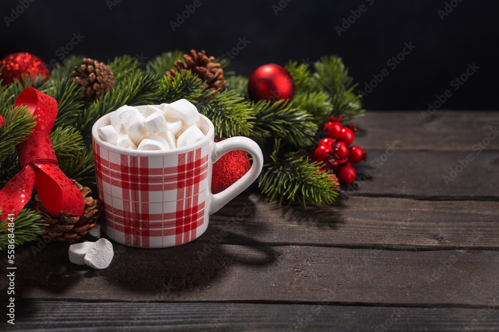 Red mug with hot chocolate on top of which pieces of marshmallows float, with copy space Red mug with hot chocolate on top of which pieces of marshmallows float, with copy space