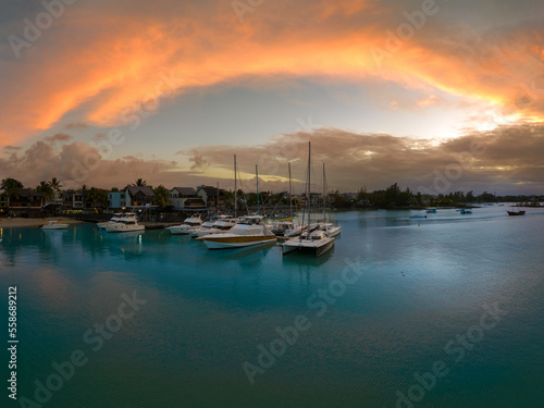 Splendid sunset at Pereybere town in Mauritius. Amazing lights over the ocean. Luxury yacht port and beautiful clear water.