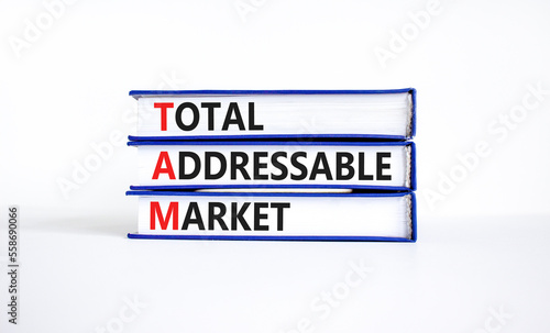 TAM total addressable market symbol. Concept words TAM total addressable market on books on a beautiful white table white background. Business TAM total addressable market concept. Copy space.
