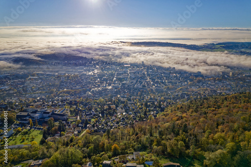 Aerial view over Swiss City of Biel Bienne, Canton Bern, seen from village Evilard on a sunny foggy autumn morning. Photo taken November 10th, 2022, Evilard, Switzerland.