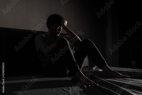 Tableau sur toile Man with depression sitting in a dark room