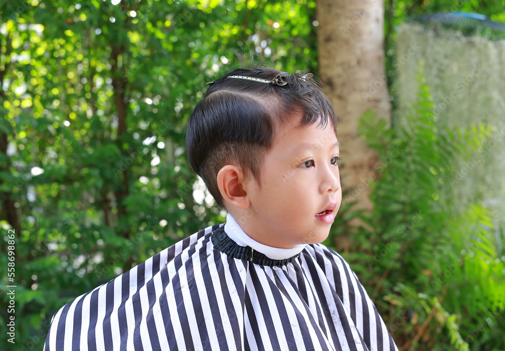 Portrait of Asian boy cut in haircut in the garden, fashion haircut for a guy. Portrait of Asian boy cut in haircut in the garden, fashion haircut for a guy.