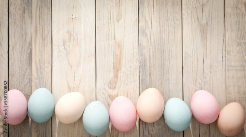 Multicolored eggs on a wooden texture. Easter background