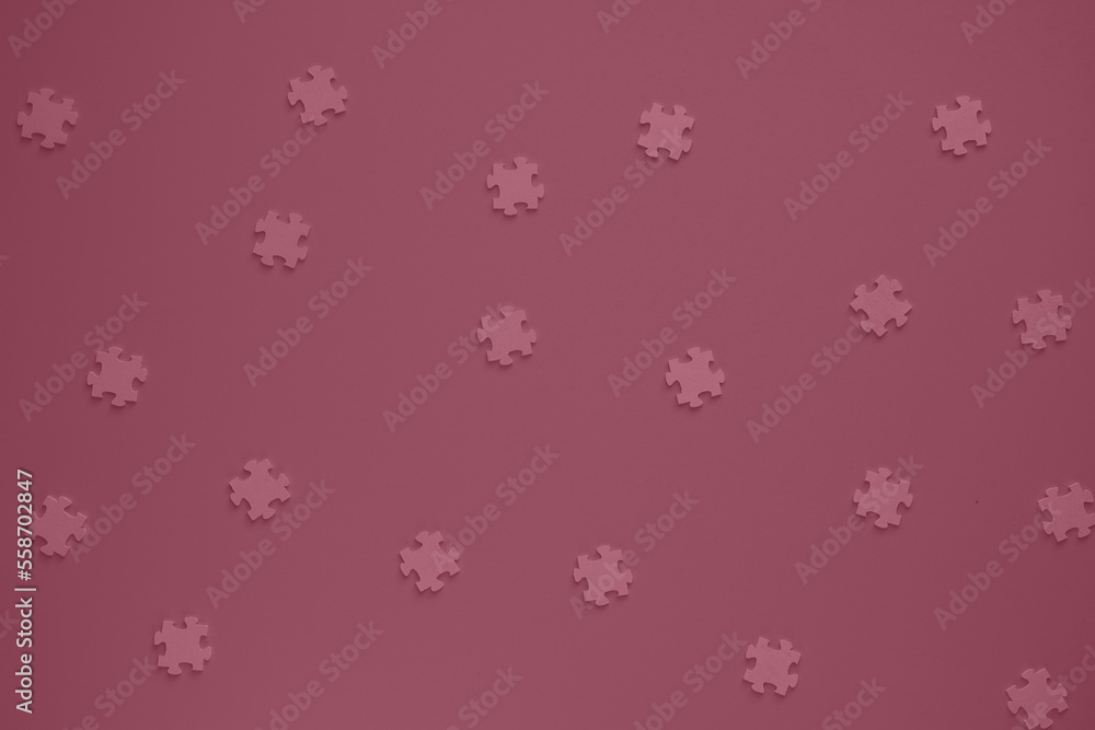 Flat blank wooden puzzles on rose background view from above. Festive background for a congratulatory inscription. New Year, Christmas, Valentine, Birthday. Festive decor. Blurred background