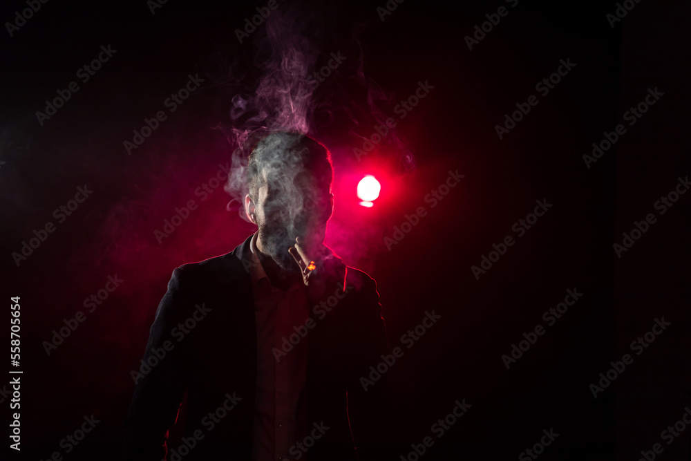 Photo of smoking man on pink background.