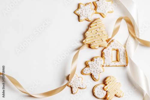 Christmas cookies with icing on a white background with ribbon photo
