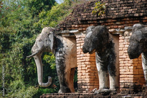 Buddhist temple Wat Sorasak with Elephants and blackened elephant heads, Sukhothai, Thailand photo