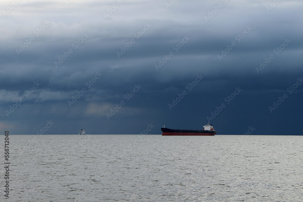 Tanker on the high seas against the backdrop of storm clouds Tanker on the high seas against the backdrop of storm clouds