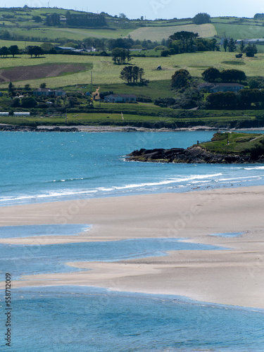 Inchydoney beach at low tide on a sunny spring day. The famous Irish beach on the south coast of the country. Seaside landscape.