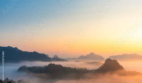 Landscape of mountains range at sunrise with morning fog for mountain background.