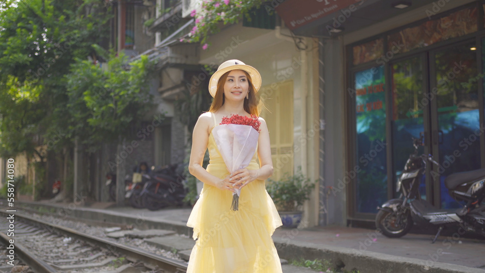 Naklejka premium Portrait of Asian Vietnamese woman girl with train railway traveling in Hanoi urban city town, Vietnam. People lifestyle.